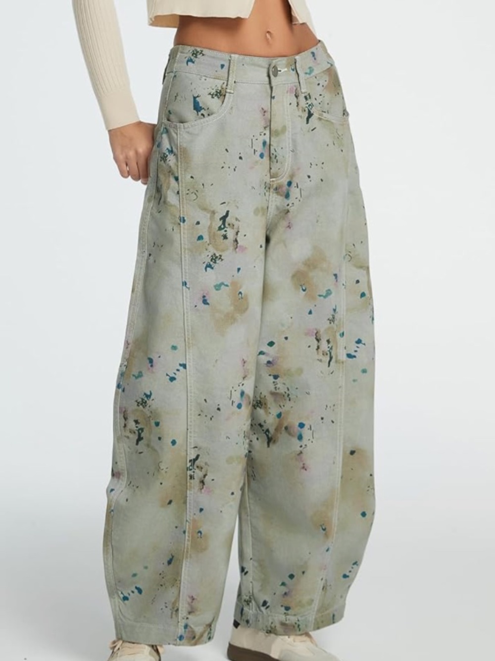 High-rise, wide leg denim with an all-over paint-splatter print. Soft light sage